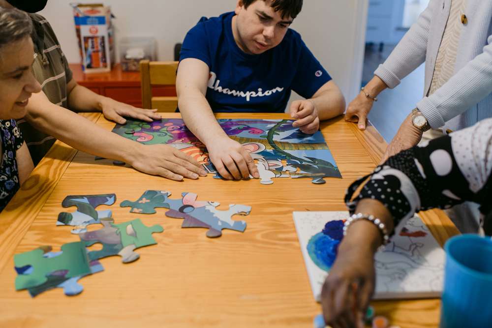 a group of people building a puzzle