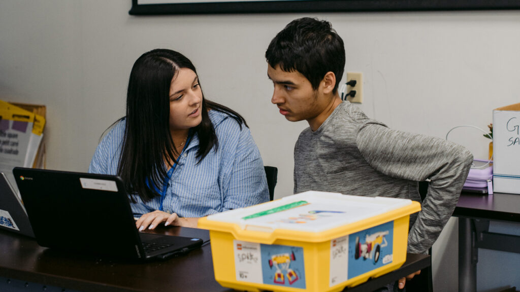 A Kerry's Place staff member working with a young client on a computer